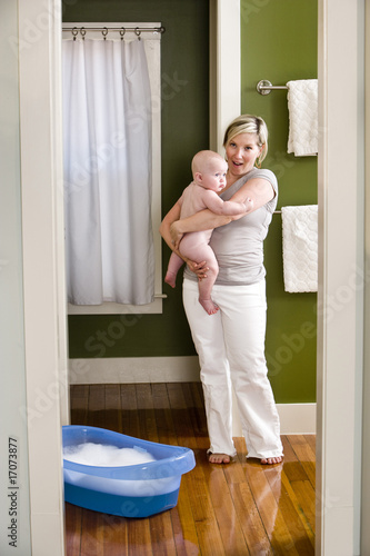 Mother preparing 7 month old baby for bath