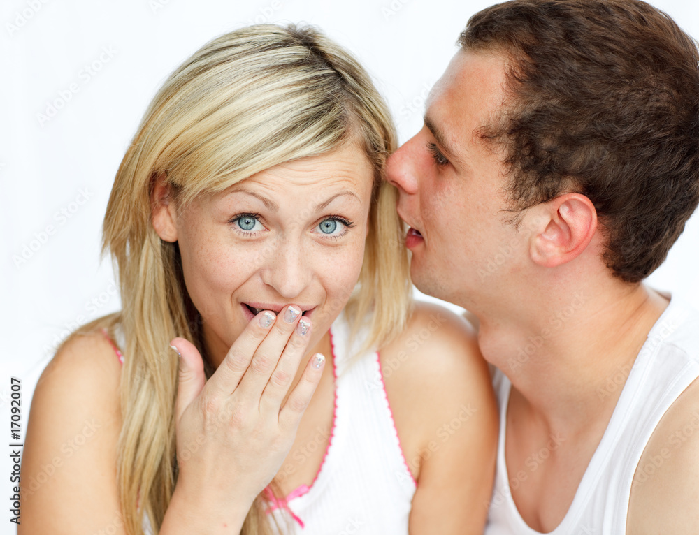 Man whispering a woman a secret Man whispering a woman a secret
