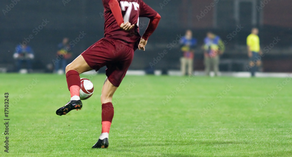 Soccer player kicking the ball