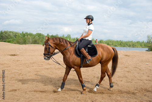Girl -a jockey on riding horse