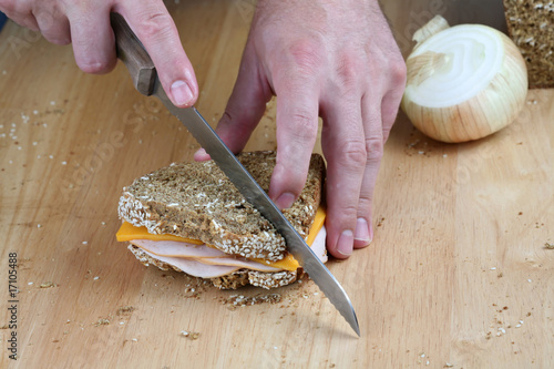 Hands cutting sandwich photo