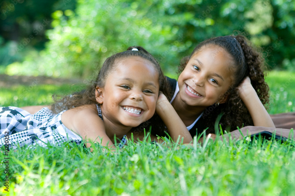 Two beautiful mixed race sisters enjoying the park Two beautiful mixed race sisters enjoying the park