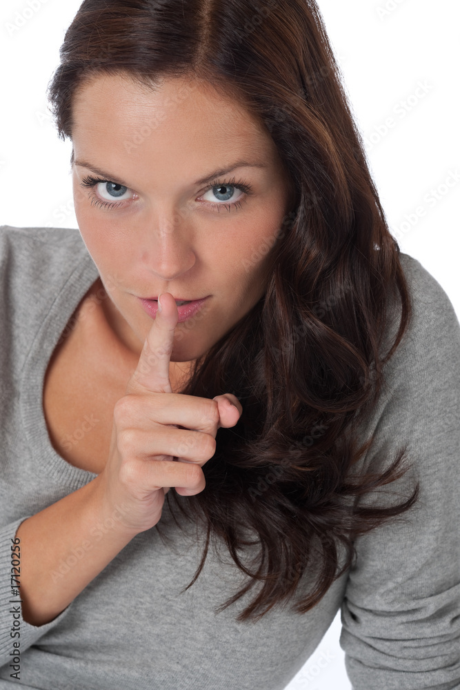 Beautiful woman expressing silence, finger on lips Beautiful woman expressing silence, finger on lips