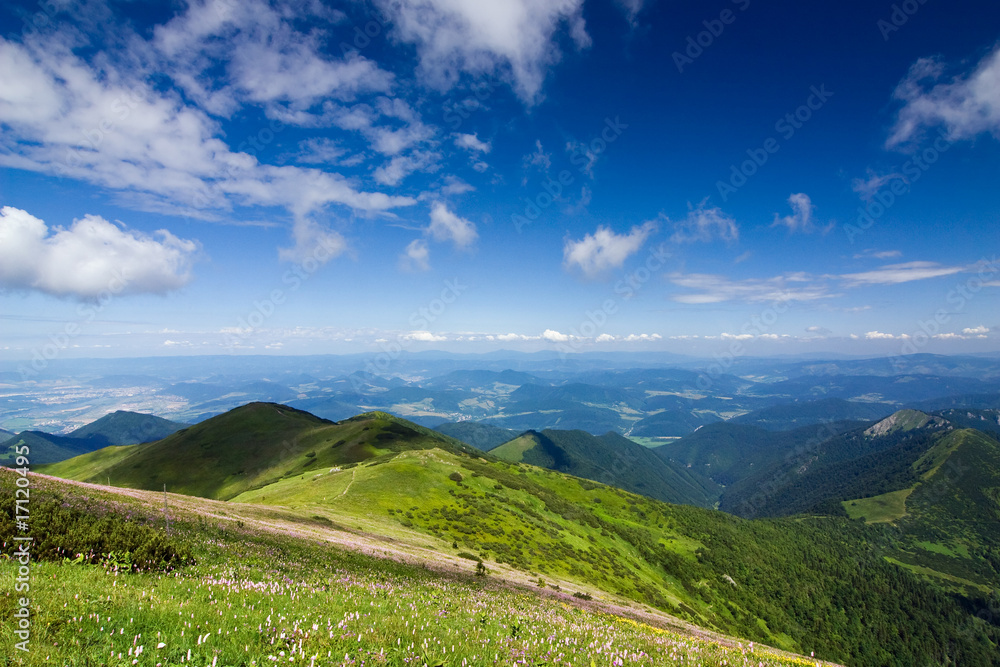 Fototapeta premium Mountain-ridge and blue sky with white clouds