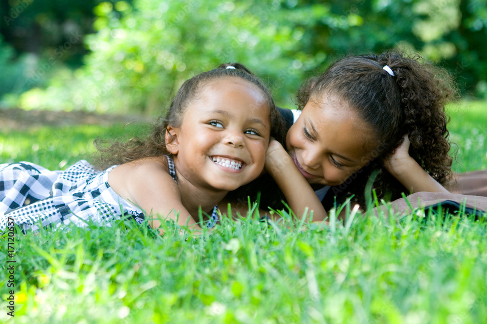 Two beautiful mixed race sisters enjoying the park Two beautiful mixed race sisters enjoying the park