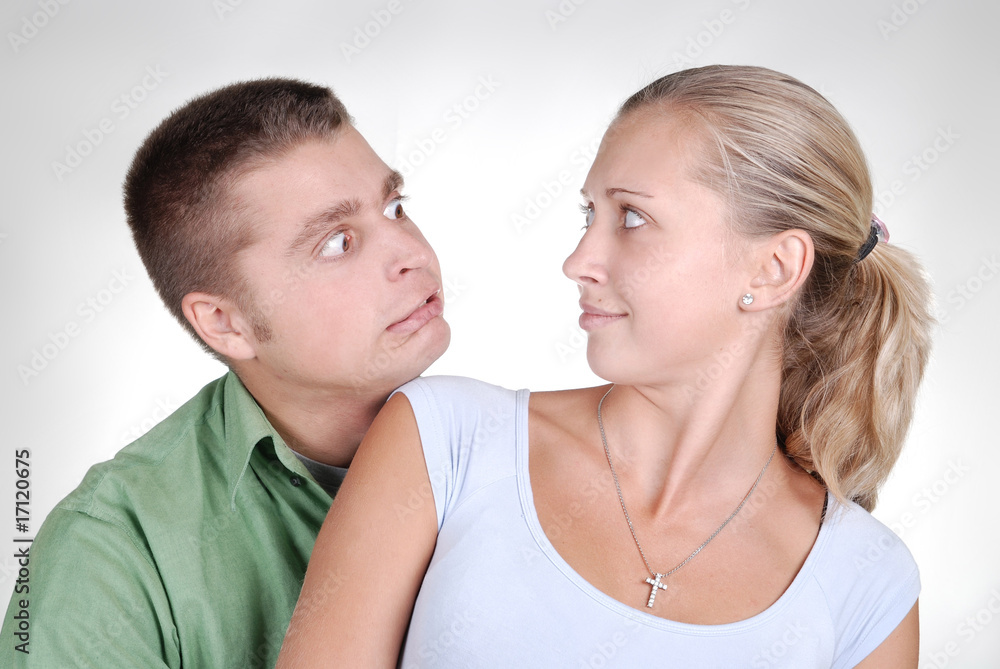 young couple looking surprisely at each other young couple looking surprisely at each other