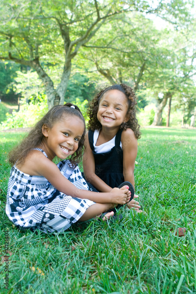 Two beautiful mixed race sisters enjoying the park Two beautiful mixed race sisters enjoying the park