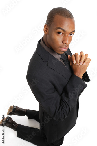 Fotografija Business man kneeling doing a prayer gesture