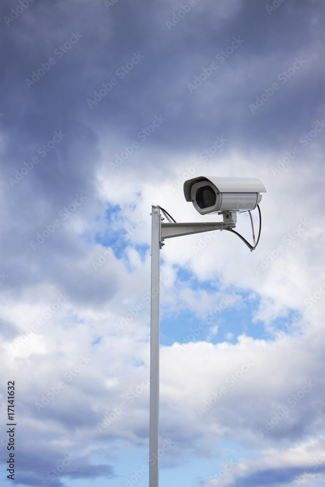 Surveillance security camera and cloudy sky Surveillance security camera and cloudy sky