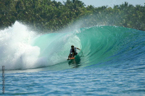 Surfer in barrel on green wave, Mentawai Islands, Indonesia photo