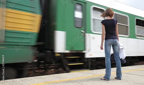 Train is coming - young woman waiting for her connection in a sm