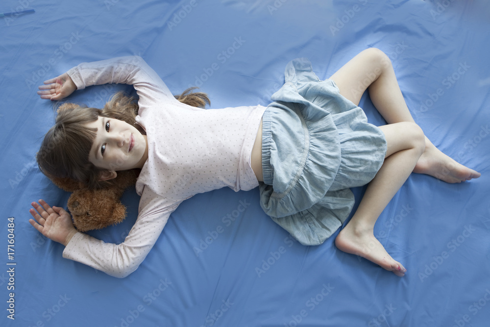 little cute girl lying on bed Stock Photo | Adobe Stock