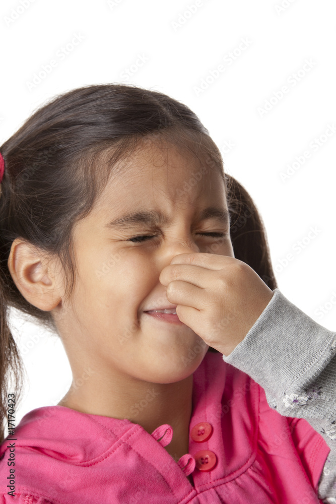 Little girl is closing her nose for a terrible smell Little girl is closing her nose for a terrible smell