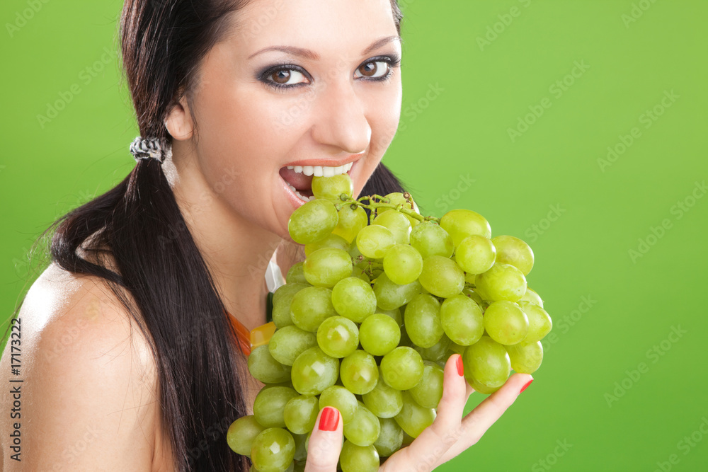 Pretty woman with grape on the green background Pretty woman with grape on the green background