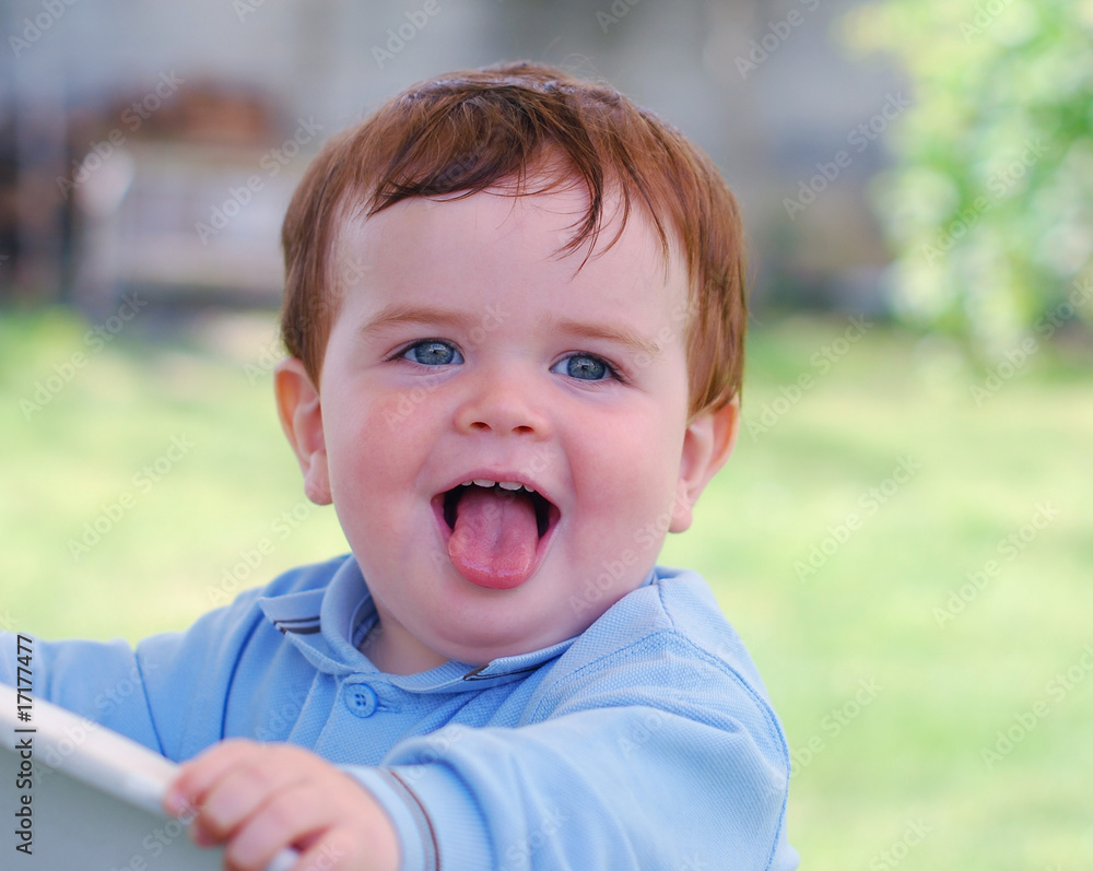 Cheerful baby showing the tongue Cheerful baby showing the tongue