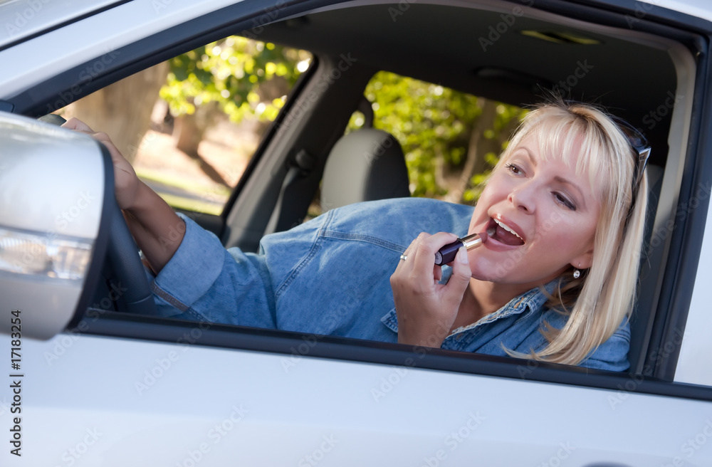 Woman Putting on Lipstick While Driving