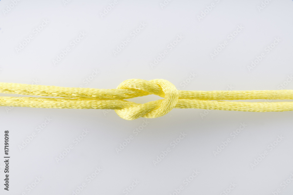 Yellow String tied in a Knot Stock Photo