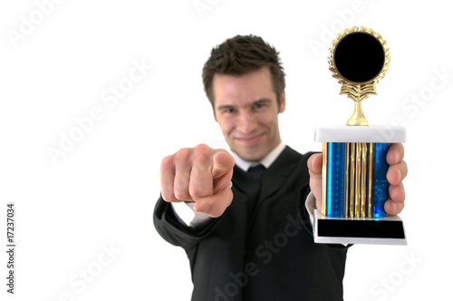 Successful businessman holding a trophy