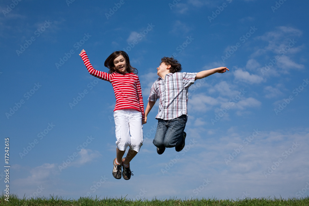 Kids jumping, running against blue sky Kids jumping, running against blue sky
