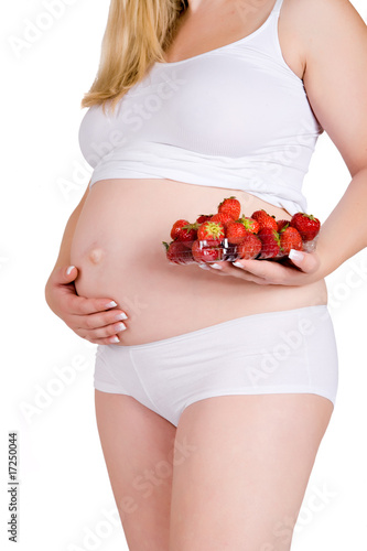 Presenting a bowl of strawberries in front of my pregnant belly