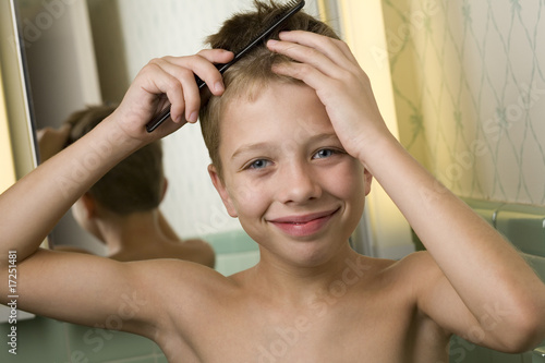 Boy combing hair