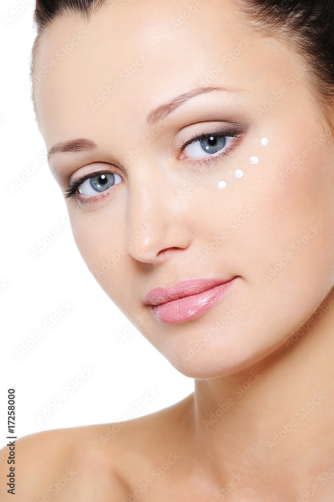 Obraz premium woman's face with moisturizer cream around eye