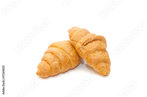 Two fresh croissant isolated over white background