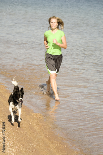 Woman and dog running in water © Poulsons Photography