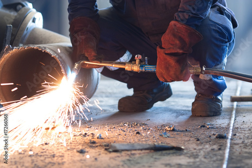 worker melting a pipe and sparks