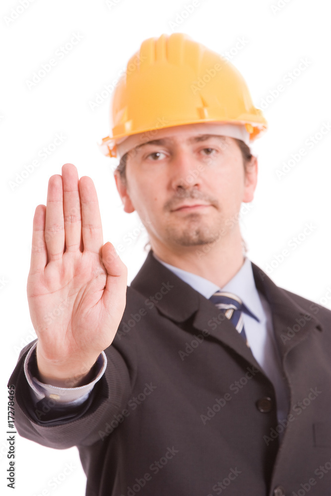 Engineer with yellow hat making stop sign Engineer with yellow hat making stop sign