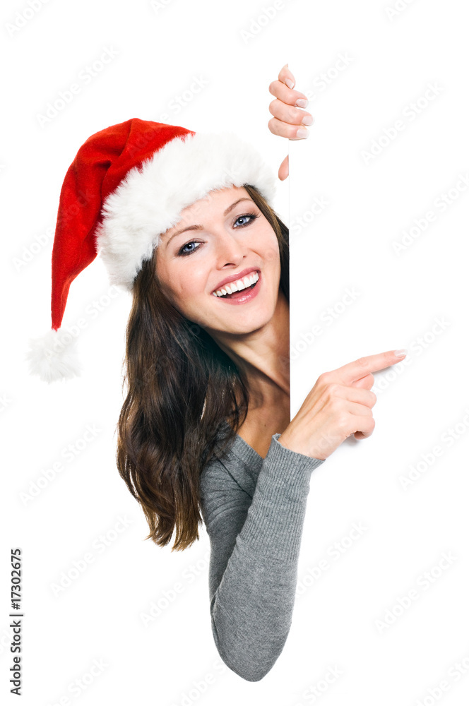 Hübsche Frau mit Weihnachtsmütze präsentiert Textfreiraum Hübsche Frau mit Weihnachtsmütze präsentiert Textfreiraum