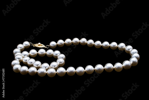 Pearls necklace on black background