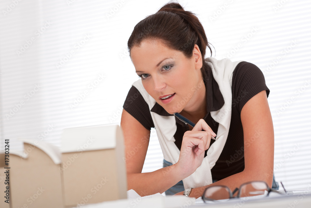 Young female architect with architectural model at the office Young female architect with architectural model at the office