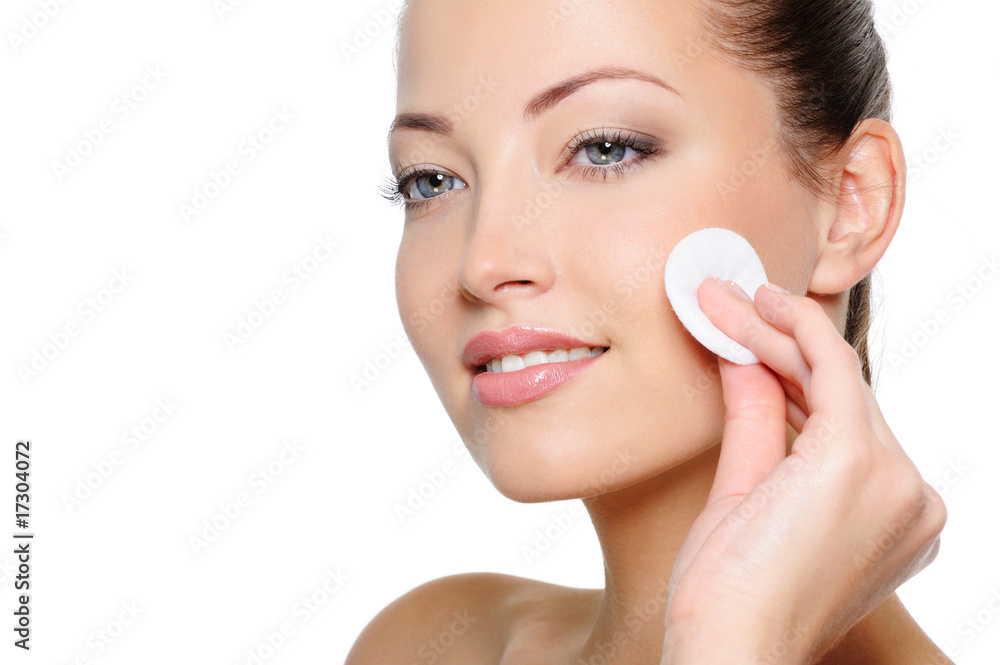 Beauty woman cleaning her health face with cotton swab Beauty woman cleaning her health face with cotton swab