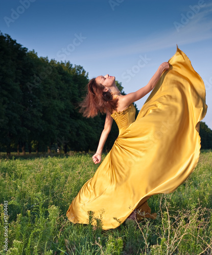 Girl dancing on the field photo