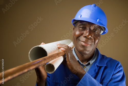 Senior South African or American plumber with pipes