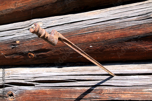 bayonet in wall of the wooden building photo