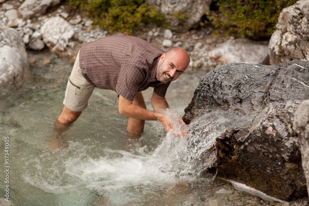 happy hiker standing in mountain stream happy hiker standing in mountain stream