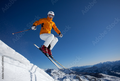 skier jumping over snowdrift