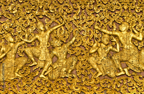 Tableau sur toile The ramayana epic carved on a wood door. Luang Prabang.