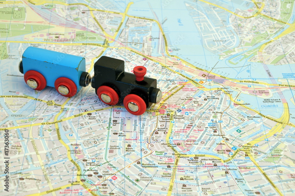 Fototapeta premium Toy train on the map of the city