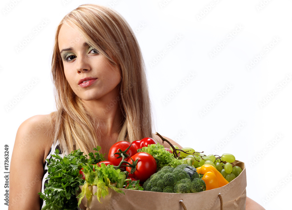 A woman holds a bags full of fresh food A woman holds a bags full of fresh food
