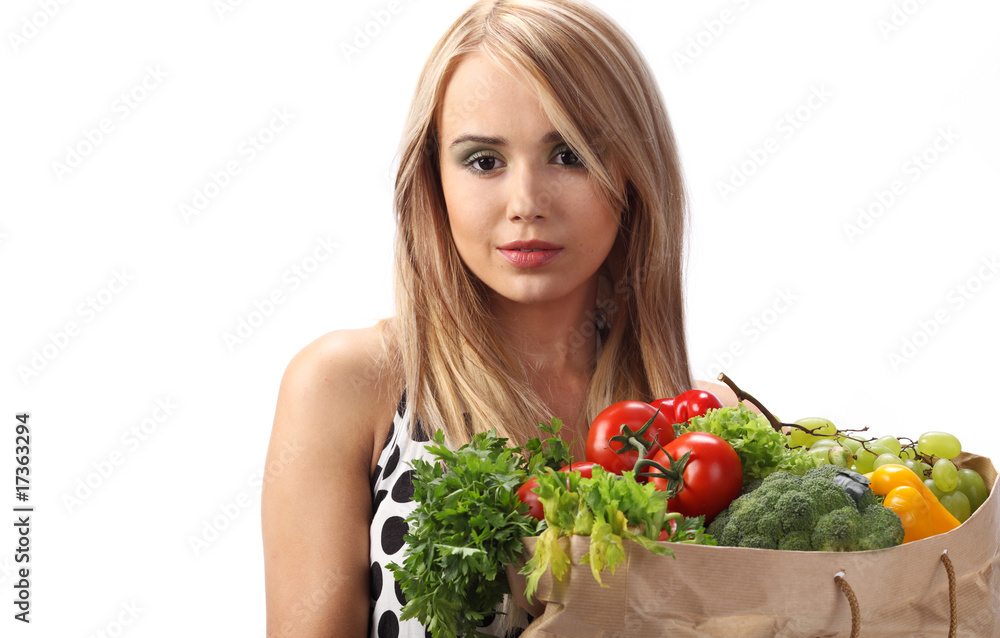 A woman holds a bags full of fresh food A woman holds a bags full of fresh food