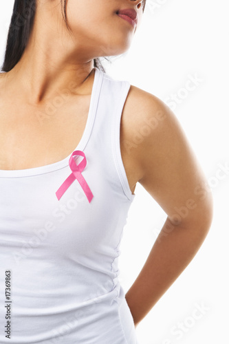 Woman using pink ribbon on her chest to support breast cancer ca