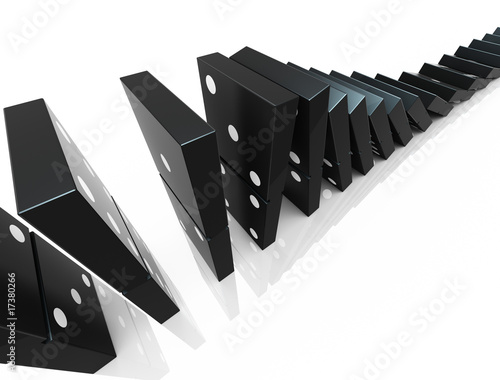 An isolated black domino blocks chain reaction on white backgrou