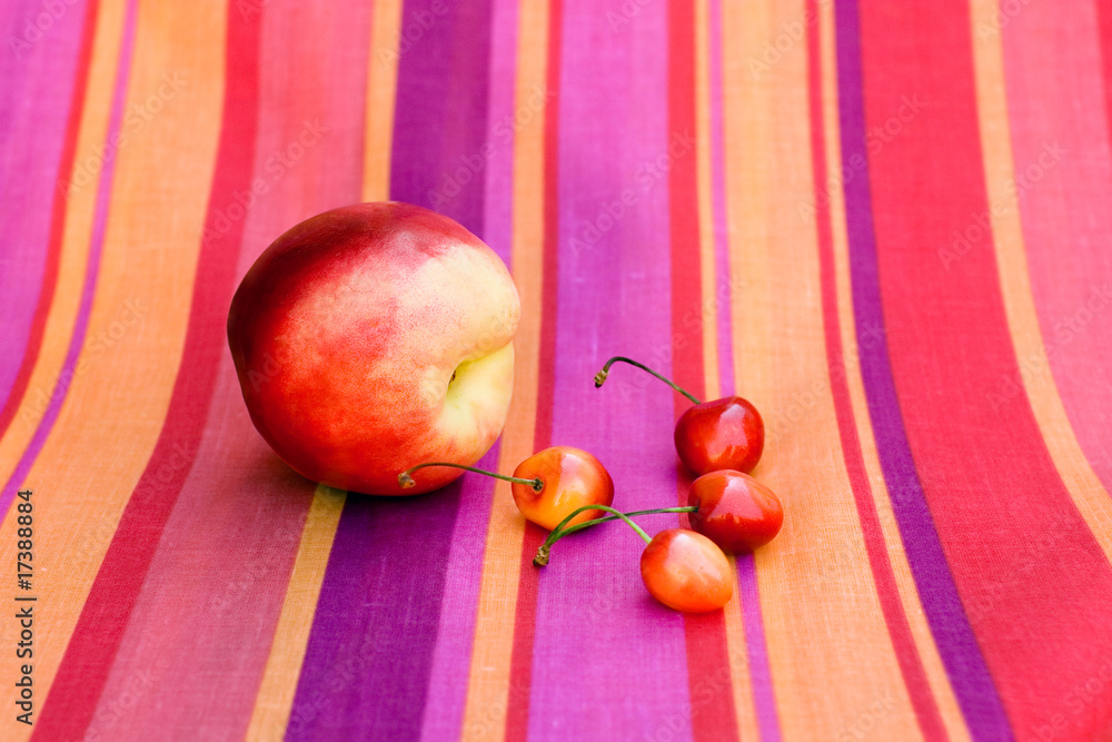 Still-life with fruit on a bright  striped cloth