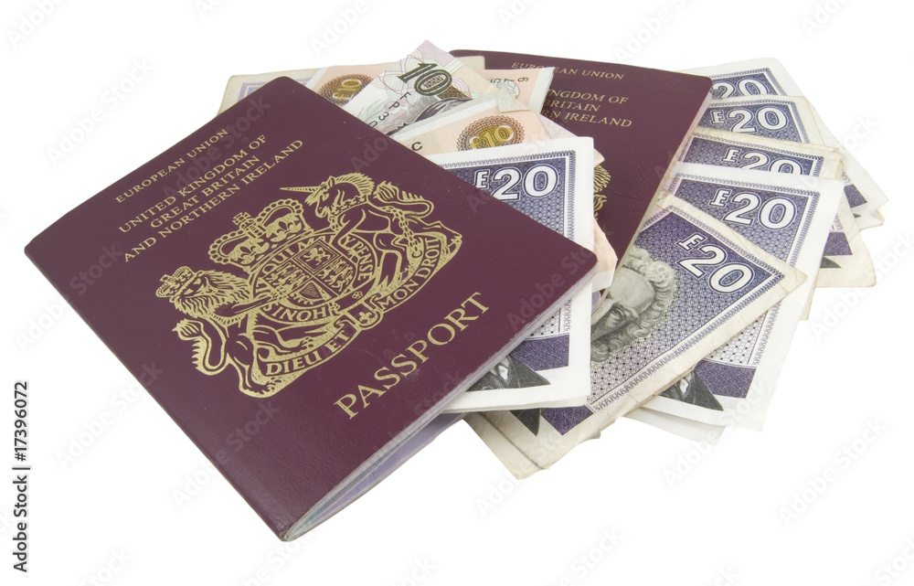 two british passports and cash isolated on white background two british passports and cash isolated on white background