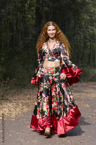 A beautiful ginger-haired girl in gipsy suit