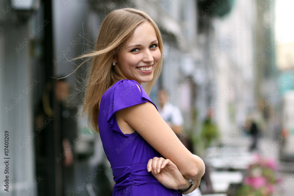 Portrait of a laughing young woman  on urban background