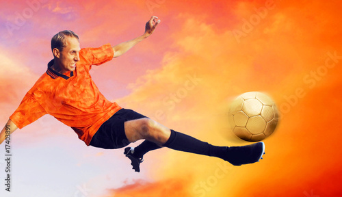 Shoot of football player on the sky with clouds